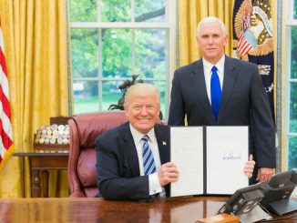 2 men in black suit sitting on red chair