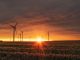 windmill on grass field during golden hour