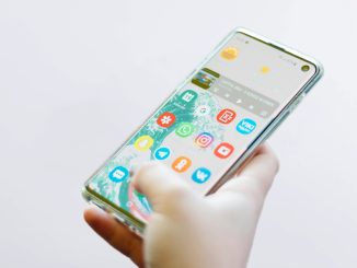 person using silver Android smartphone