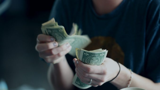 Photo by Alexander Grey focus photography of person counting dollar banknotes