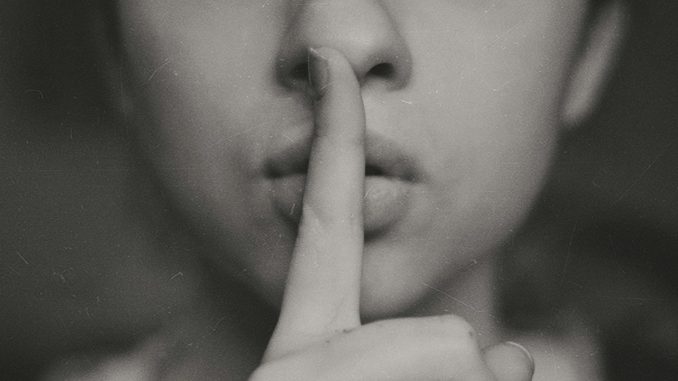 Photo by Kristina Flour grayscale photo of woman doing silent hand sign