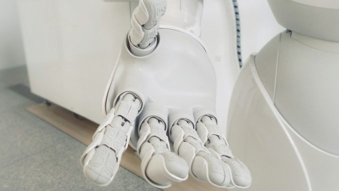 Photo by Possessed Photography closeup photo of white robot arm