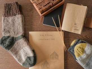 white and blue knit sock beside brown wooden box
