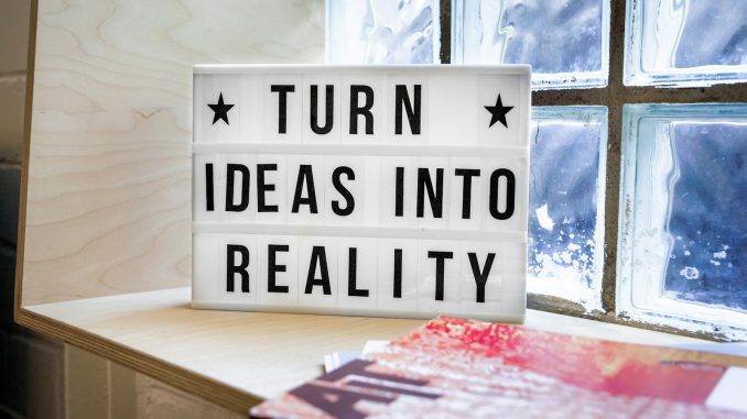 Photo by Mika Baumeister white and black wooden quote board