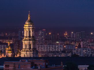 white and green tower during night time