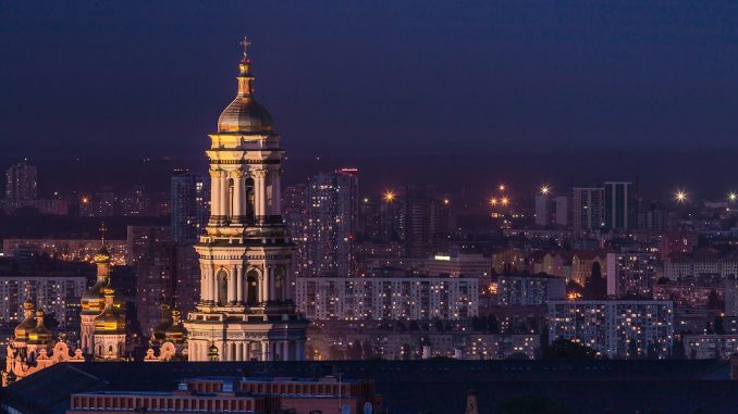 Photo by Eugene white and green tower during night time