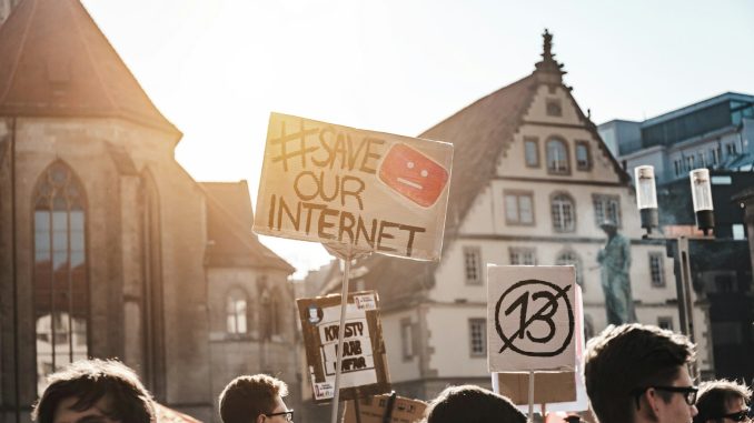 Photo by Sara Kurfeß person holding save our internet signage during daytime
