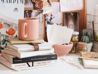brown ceramic coffee mug on book