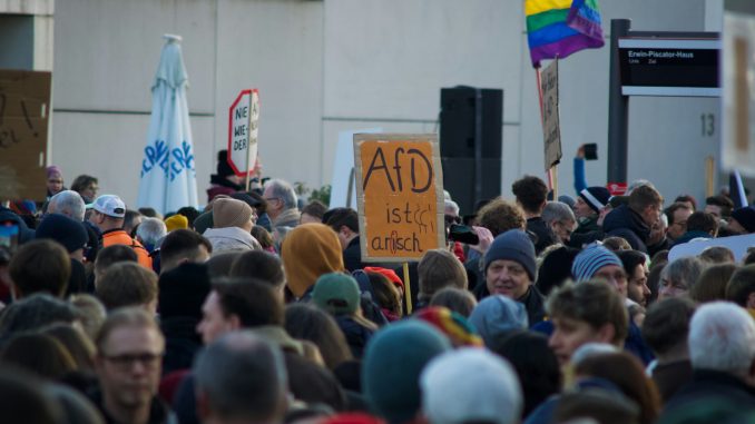 Photo by Christian Lue a large group of people standing around each other