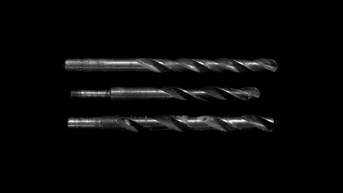 grayscale photo of drill bits